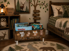 Load image into Gallery viewer, A rustic children's bedroom scene featuring a wooden toy storage bin with animal illustrations and the phrase 'Once upon a time' on the front, styled with books, a lantern, wall decals, and a bed with woodland-themed bedding.
